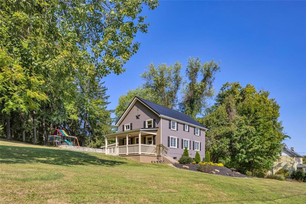 1585 Rte 481 Charleroi, PA 15022 - Photo 2 of 37 a front view of a house with a yard table and chairs