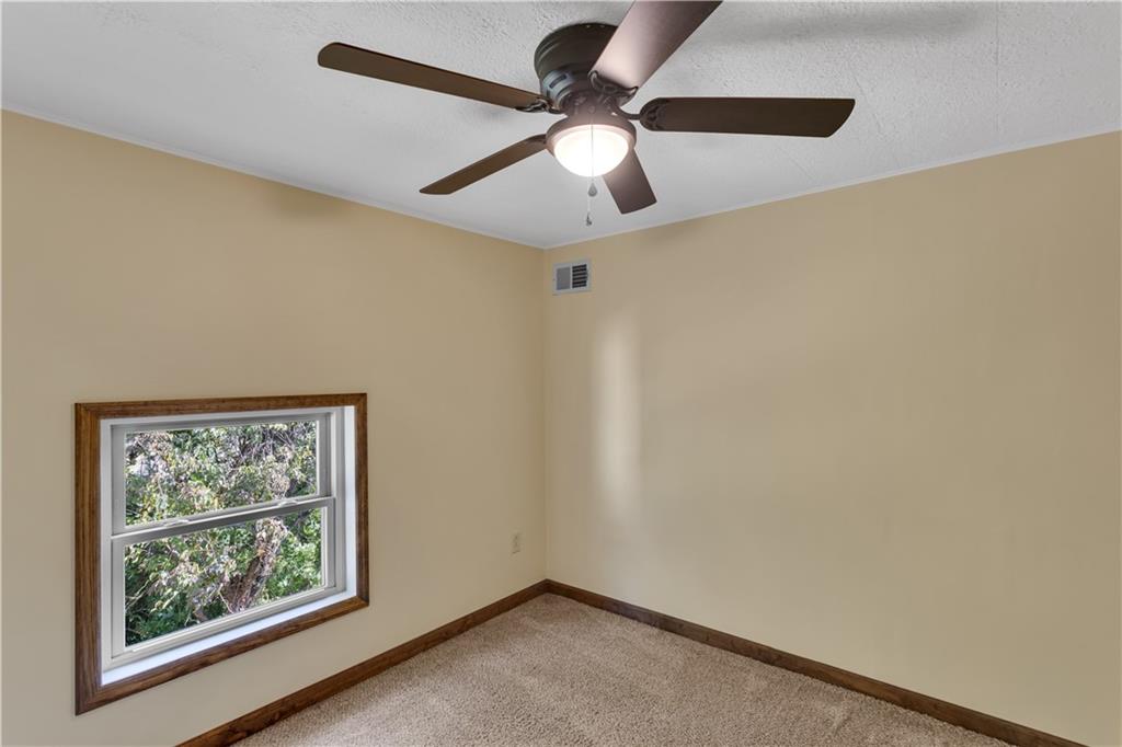 1585 Rte 481 Charleroi, PA 15022 - Photo 22 of 37 an empty room with a window and a ceiling fan