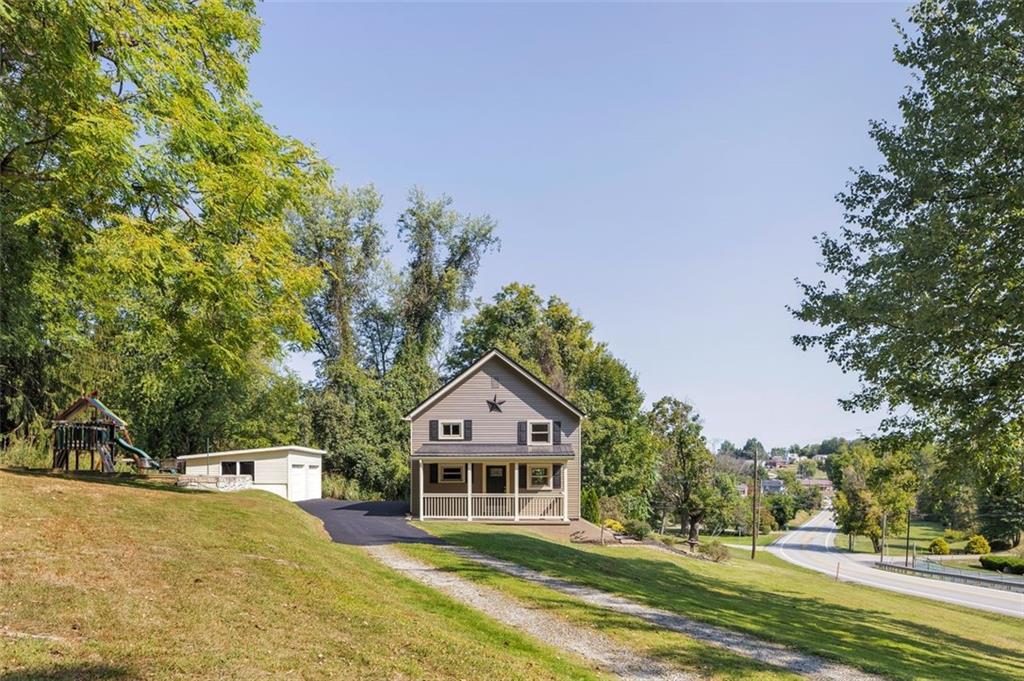1585 Rte 481 Charleroi, PA 15022 - Photo 4 of 37 a front view of a house with a yard and trees