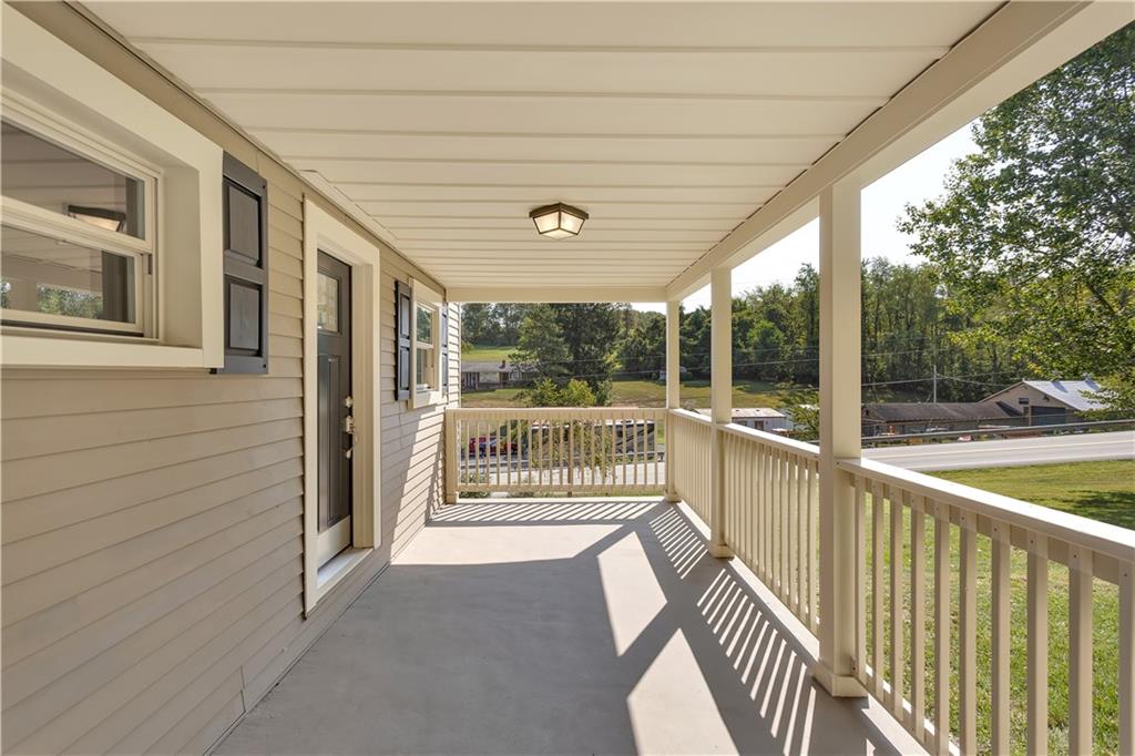 1585 Rte 481 Charleroi, PA 15022 - Photo 5 of 37 a view of a porch with wooden floor and floor to ceiling window