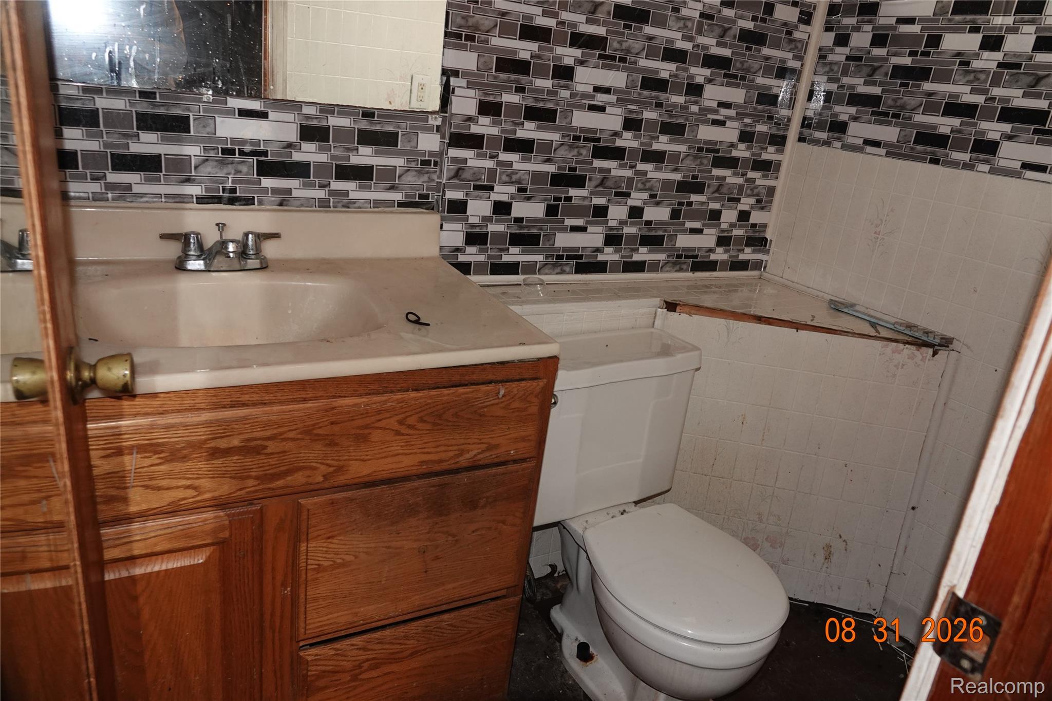 7654 Fielding Street Detroit, MI 48228 - Photo 18 of 23 Wood-finish vanity with an integrated sink and chrome faucet