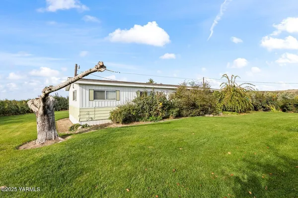 a view of a house with a yard and sitting area