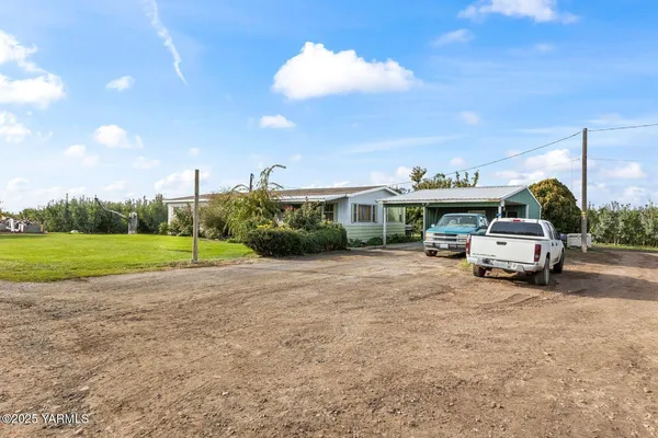 a view of a house with truck parked on the road