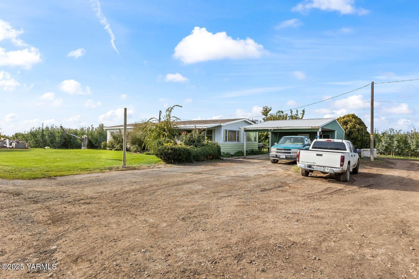 370 Macy Road Zillah, WA 98953 - Photo 15 of 42 a view of a house with truck parked on the road