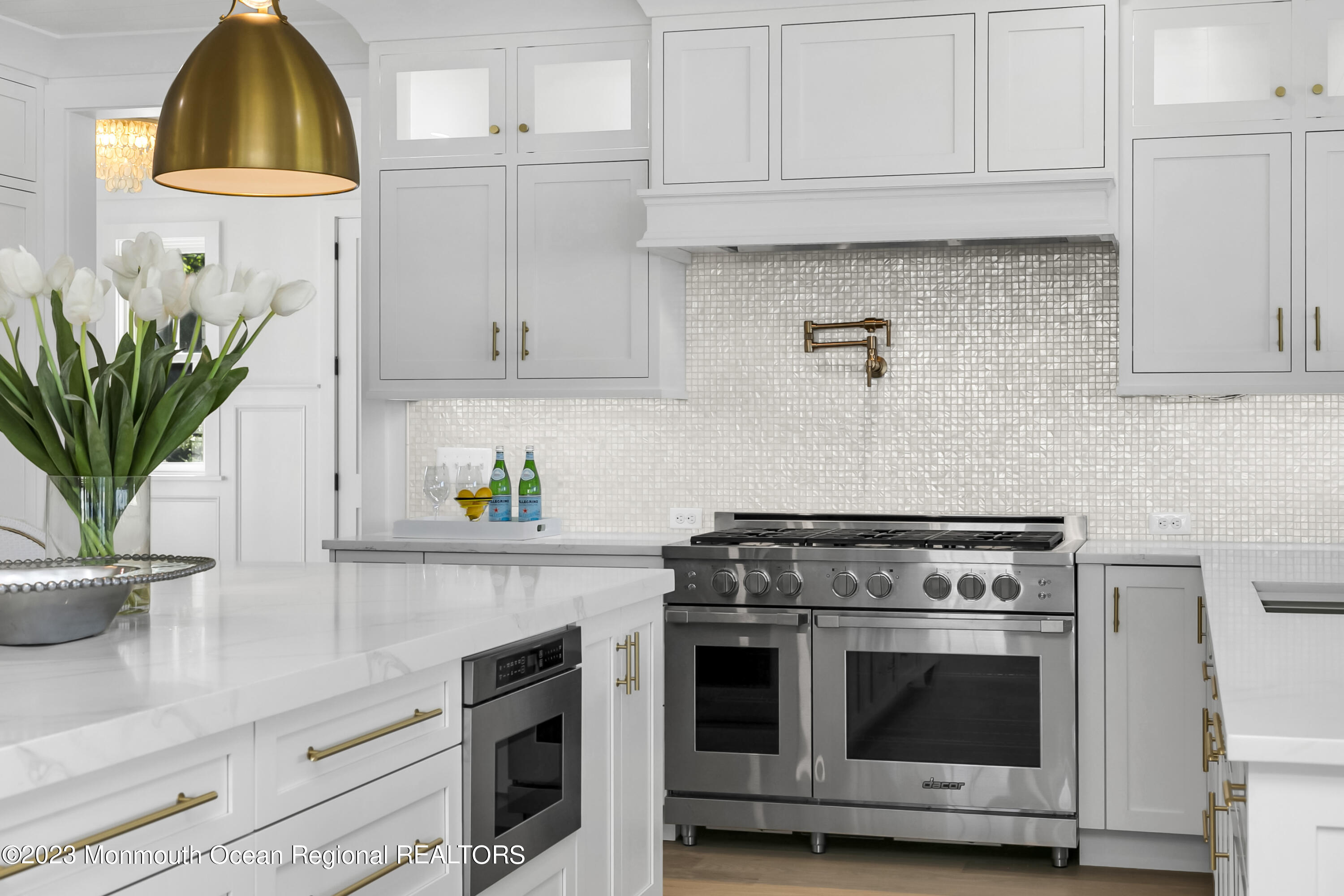 65 South Boulevard Spring Lake, NJ 07762 - Photo 16 of 80 a kitchen with stainless steel appliances a stove a white cabinets and a potted plant