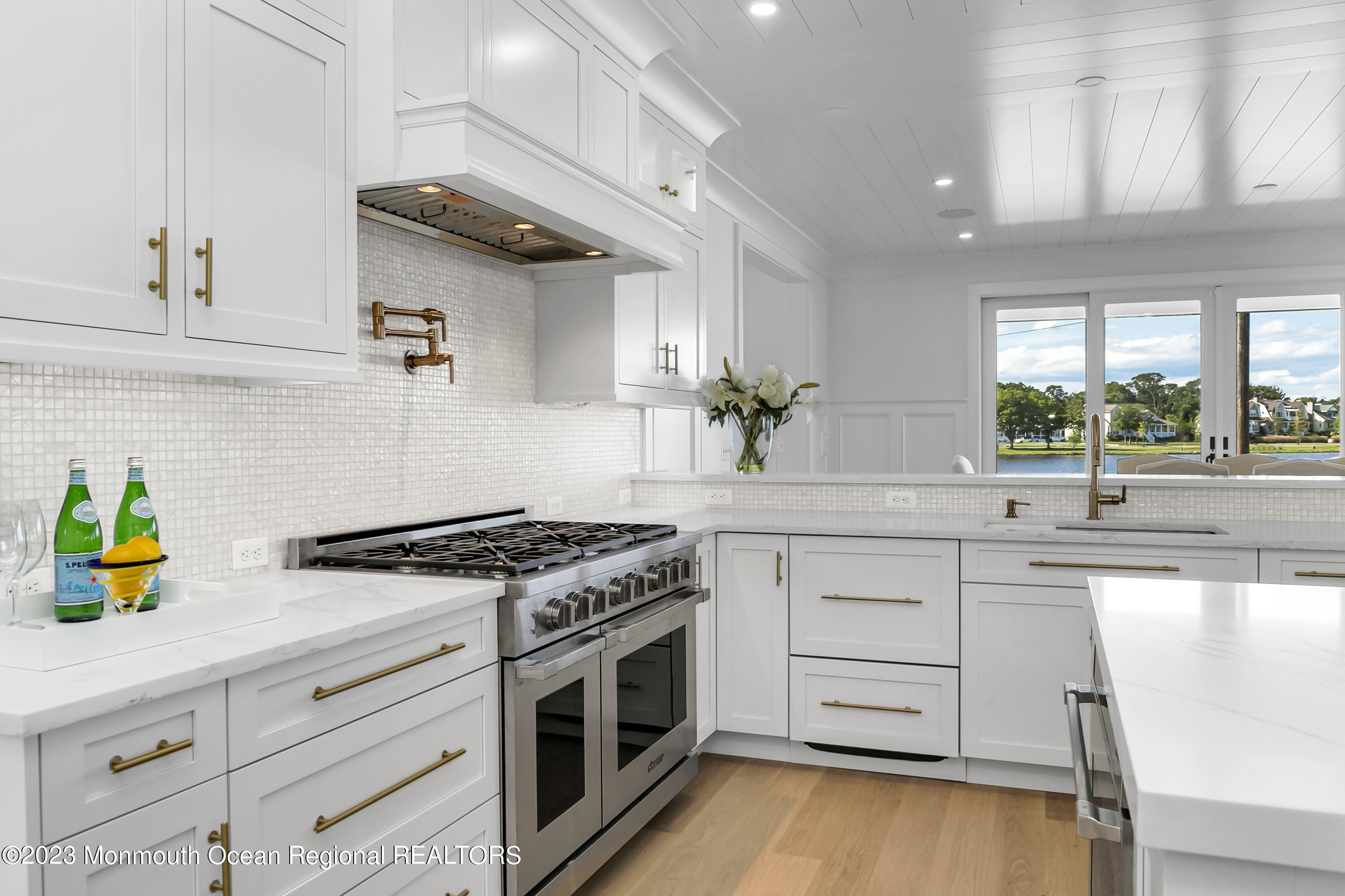 65 South Boulevard Spring Lake, NJ 07762 - Photo 20 of 80 a kitchen with stainless steel appliances granite countertop a stove a sink and a granite counter tops with wooden floors