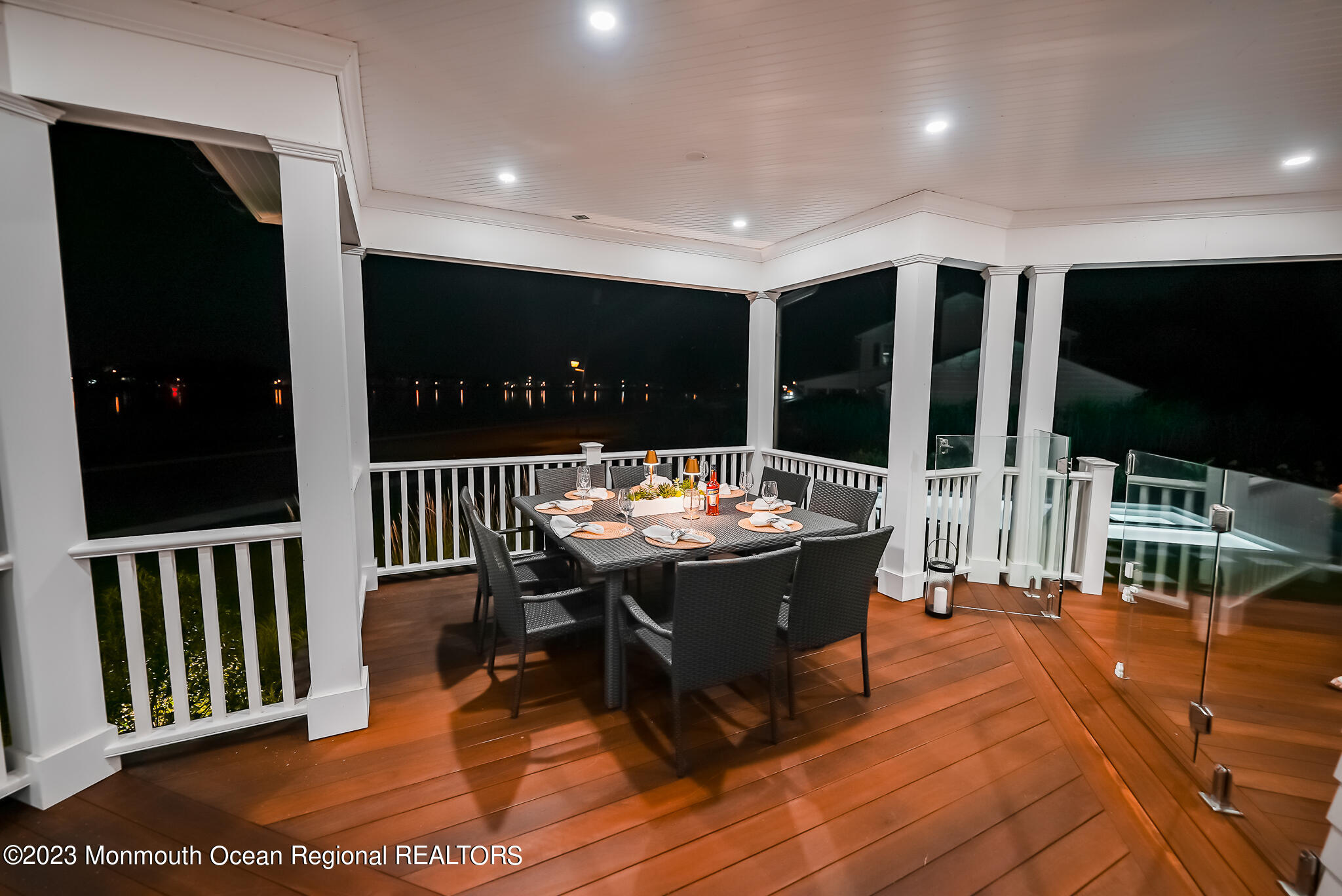 65 South Boulevard Spring Lake, NJ 07762 - Photo 30 of 80 a view of a patio with dining table and chairs with wooden floor