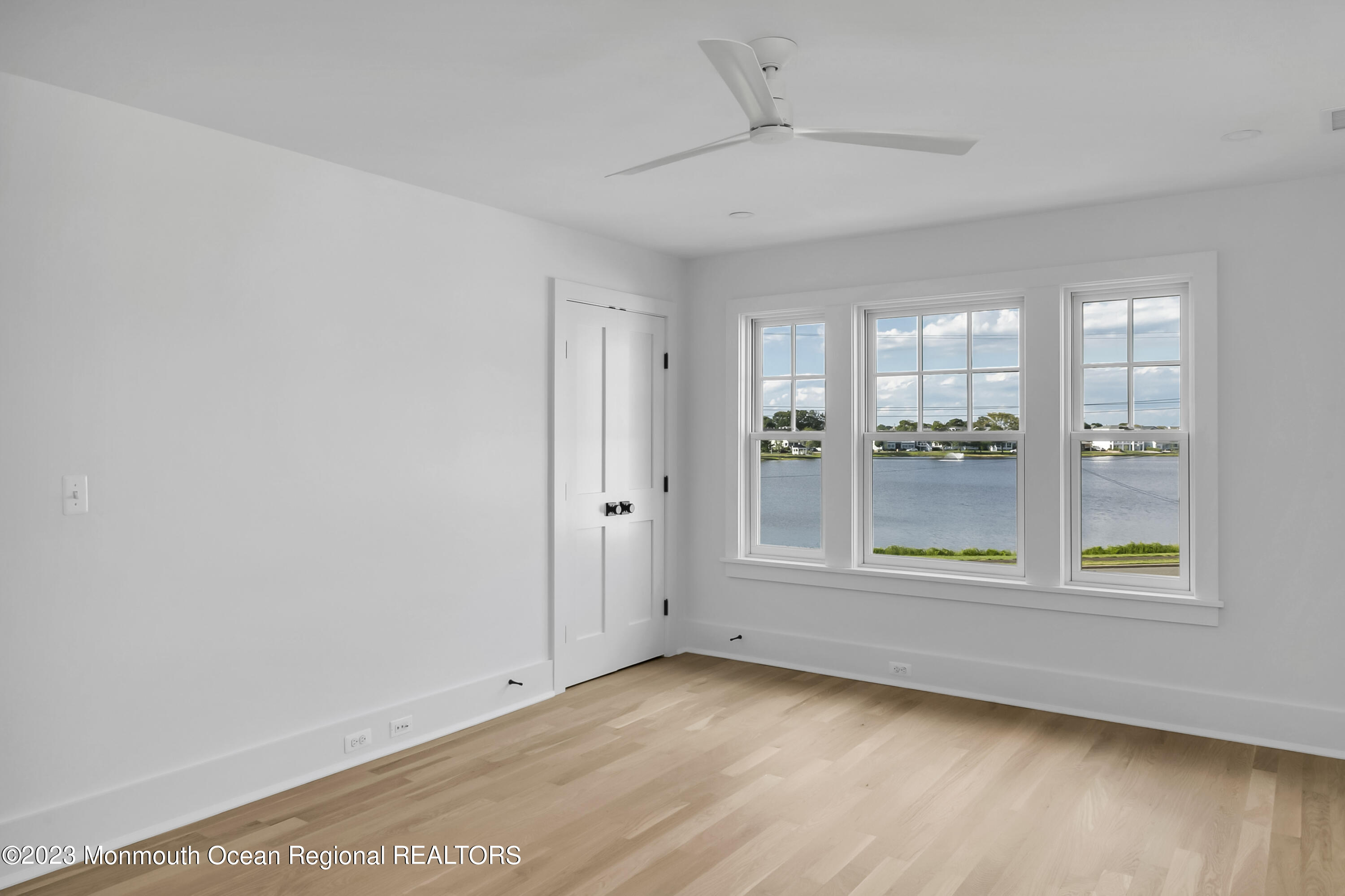 65 South Boulevard Spring Lake, NJ 07762 - Photo 65 of 80 a view of an empty room with a window and wooden floor