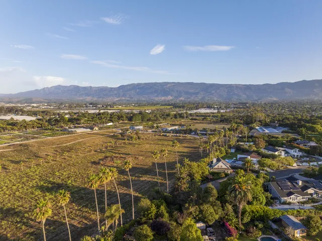 an aerial view of residential building and ocean