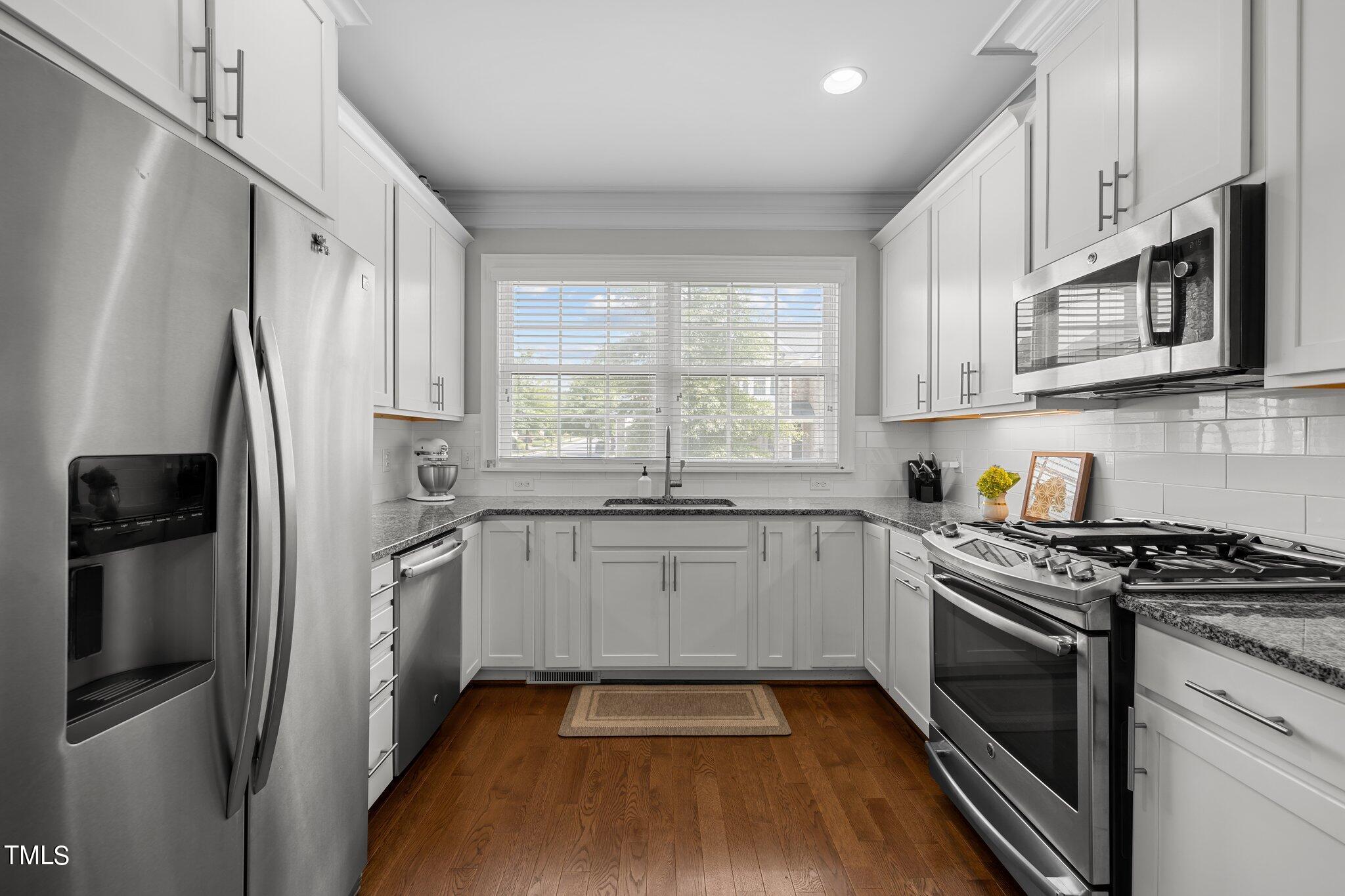 504 Valleyshire Road Durham, NC 27707 - Photo 11 of 38 a kitchen with stainless steel appliances a stove a sink and a refrigerator