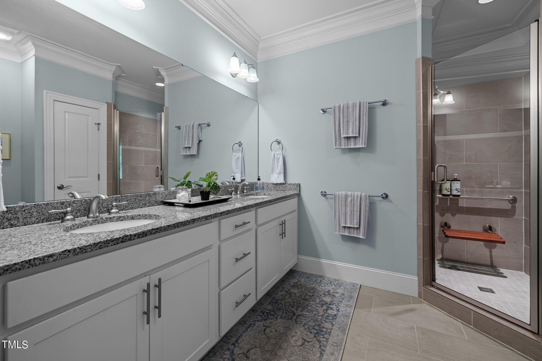 504 Valleyshire Road Durham, NC 27707 - Photo 16 of 38 a spacious bathroom with a granite countertop sink and a mirror