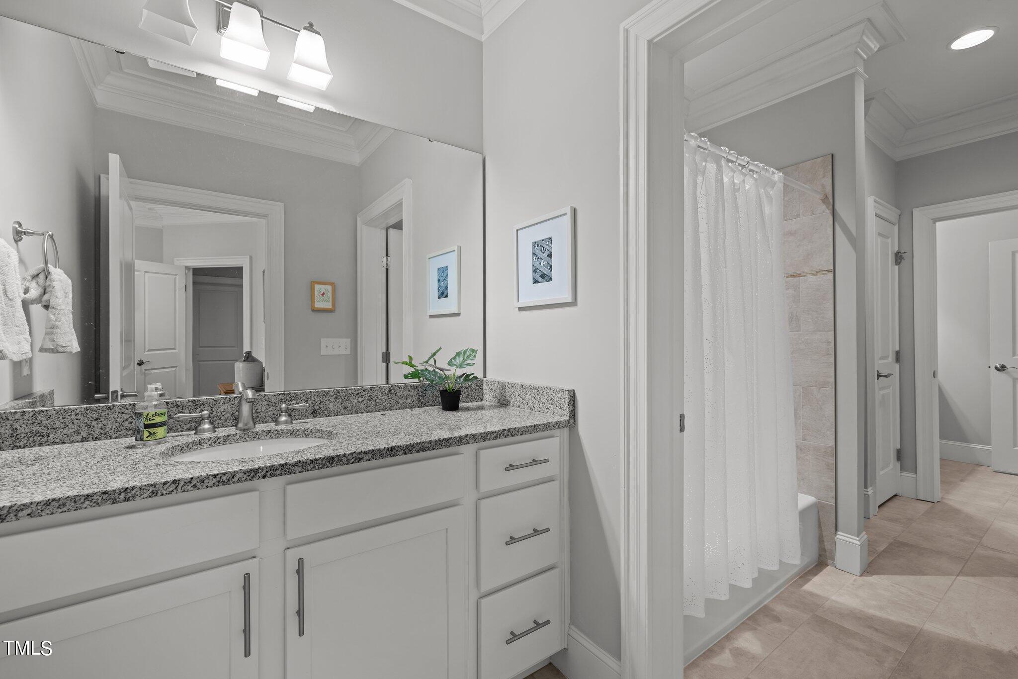 504 Valleyshire Road Durham, NC 27707 - Photo 25 of 38 a bathroom with a granite countertop sink and a mirror