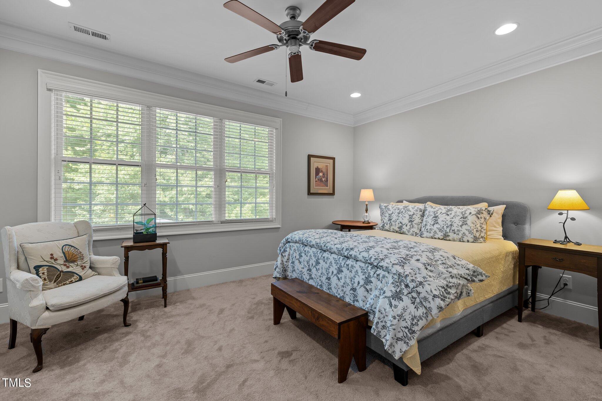 504 Valleyshire Road Durham, NC 27707 - Photo 28 of 38 a bedroom with a bed and a chandelier