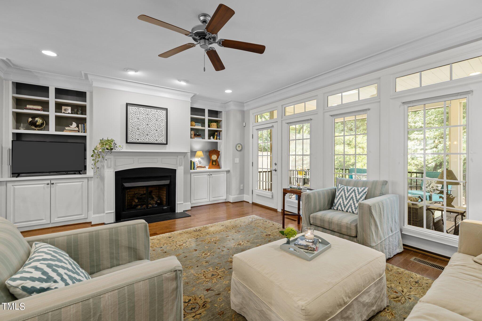 504 Valleyshire Road Durham, NC 27707 - Photo 4 of 38 a living room with furniture a flat screen tv and a fireplace