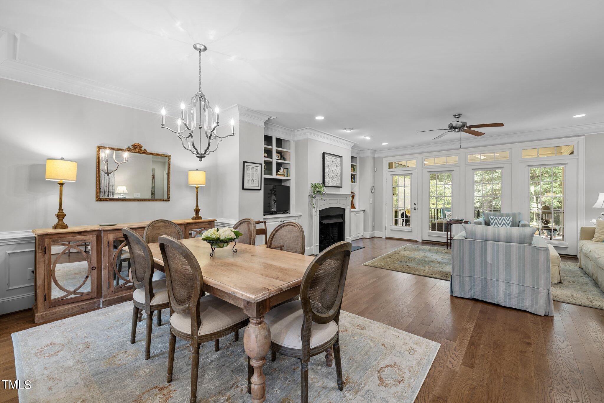 504 Valleyshire Road Durham, NC 27707 - Photo 8 of 38 a view of a dining room with furniture a chandelier and wooden floor