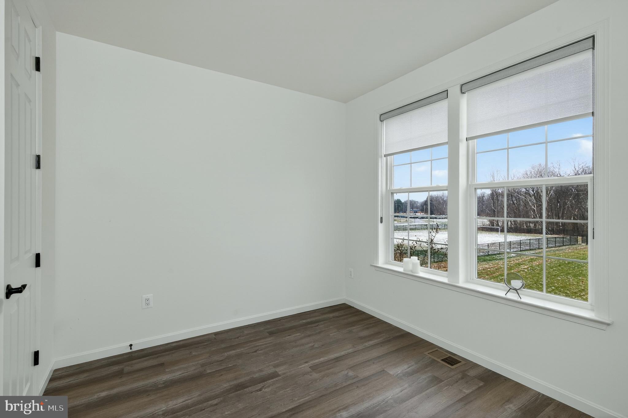 401 Karn Place Brunswick, MD 21716 - Photo 33 of 82 a view of an empty room with wooden floor and a window