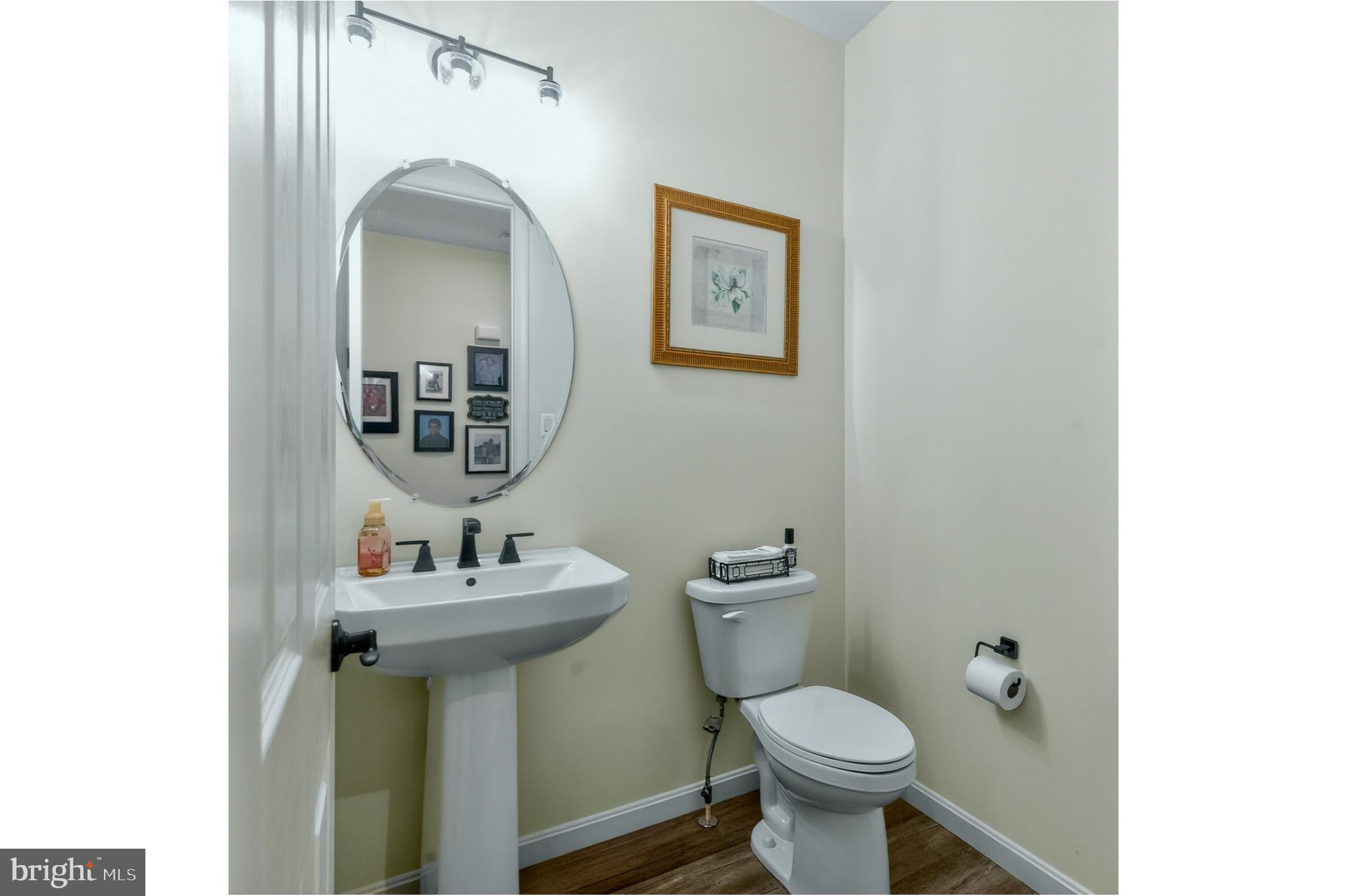 401 Karn Place Brunswick, MD 21716 - Photo 36 of 82 a bathroom with a toilet sink and mirror
