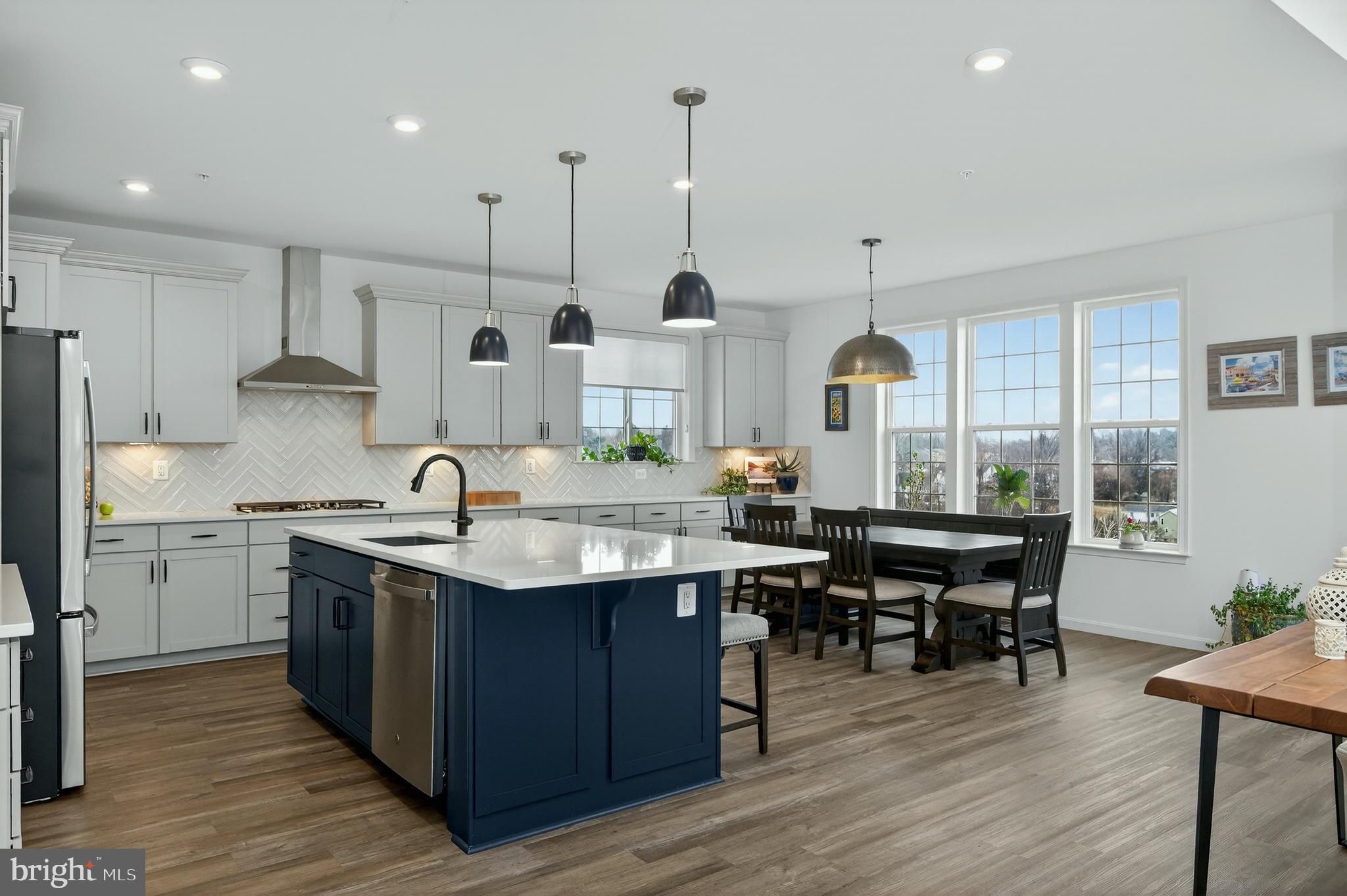401 Karn Place Brunswick, MD 21716 - Photo 5 of 82 a kitchen with stainless steel appliances granite countertop a sink a stove and a wooden floors