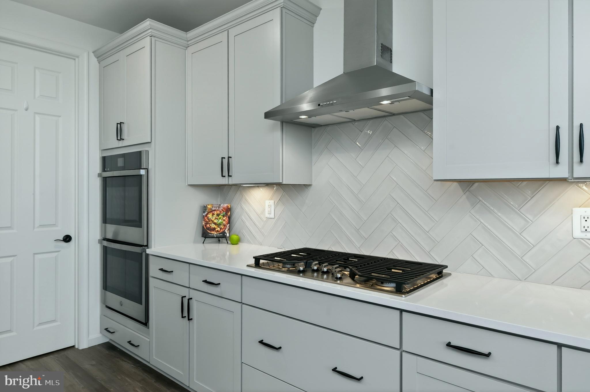 401 Karn Place Brunswick, MD 21716 - Photo 7 of 82 a kitchen with stainless steel appliances white cabinets and a stove