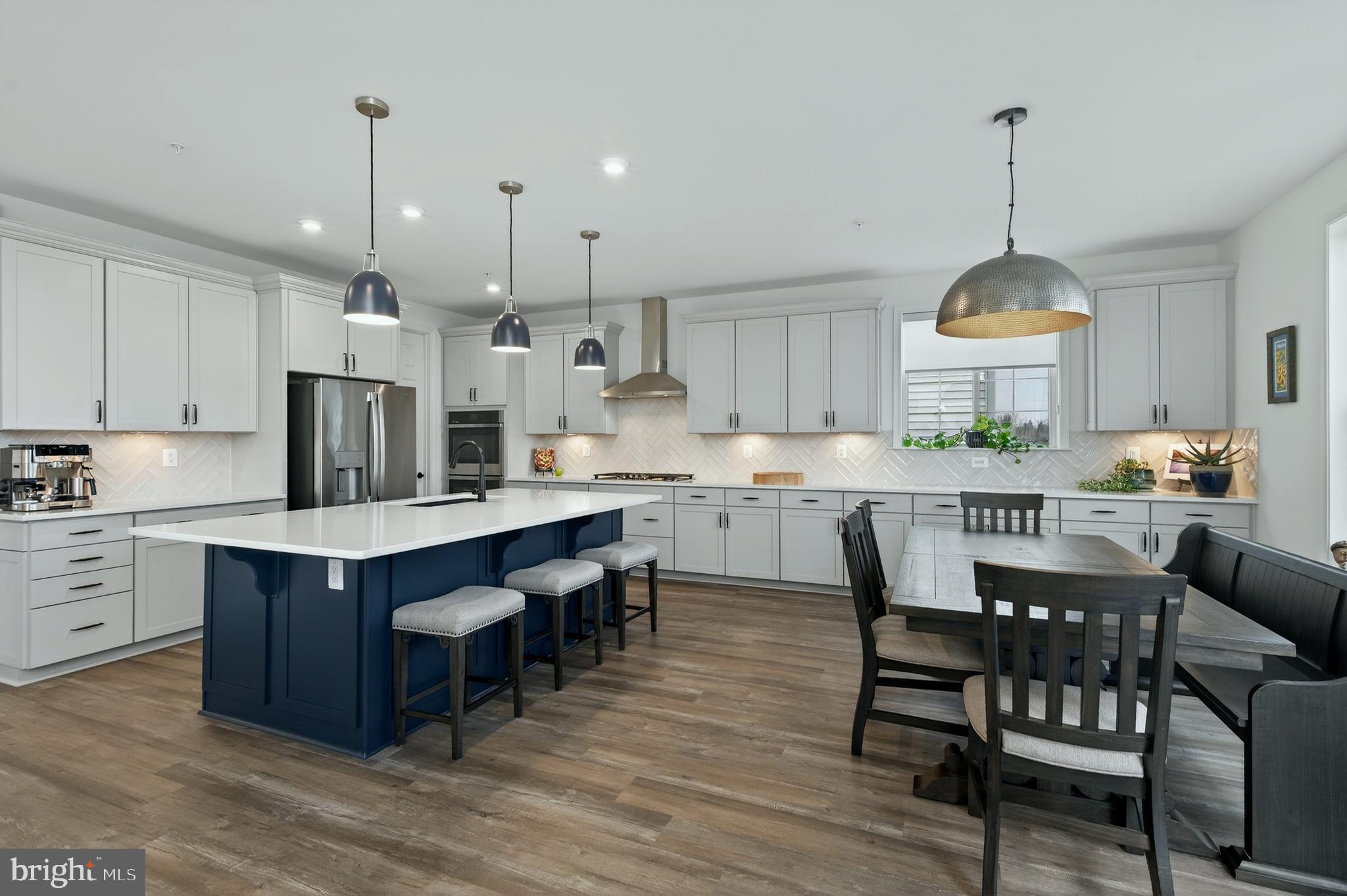 401 Karn Place Brunswick, MD 21716 - Photo 8 of 82 a kitchen that has a lot of cabinets in it wooden floors and stainless steel appliances