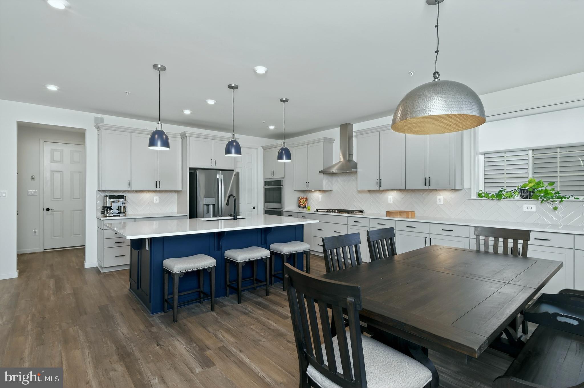 401 Karn Place Brunswick, MD 21716 - Photo 9 of 82 a kitchen with kitchen island a dining table and chairs