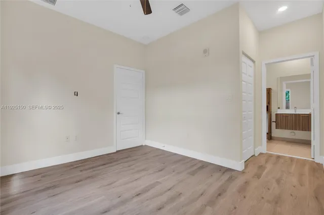 a view of a room with wooden floor