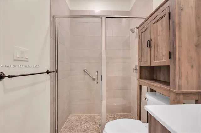 a bathroom with a shower toilet and sink