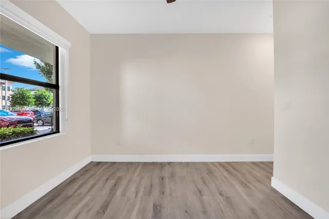 a view of a room with wooden floor and window