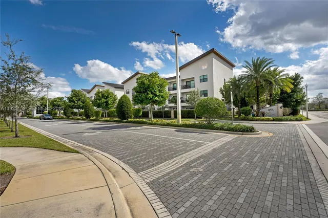 a view of a house with a yard and a fountain