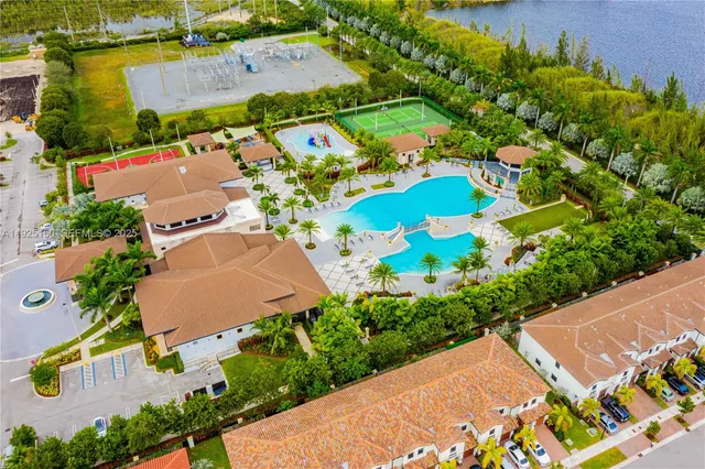 an aerial view of a house with a garden and swimming pool