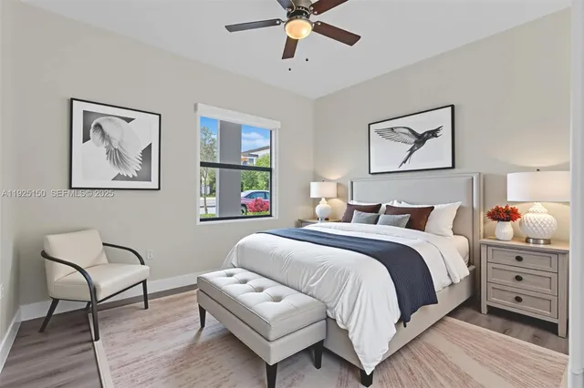 a bedroom with a bed a couch and a painting on the wall