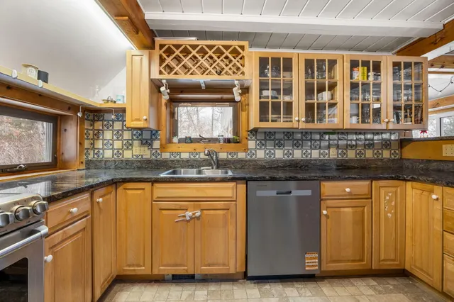 a kitchen with stainless steel appliances granite countertop a stove and a sink