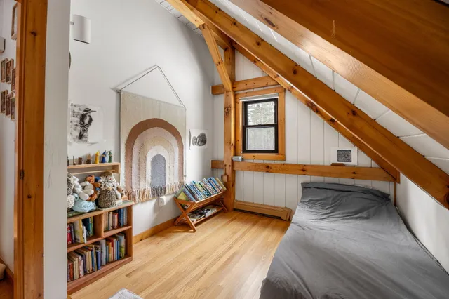 a bedroom with a bed and a large window