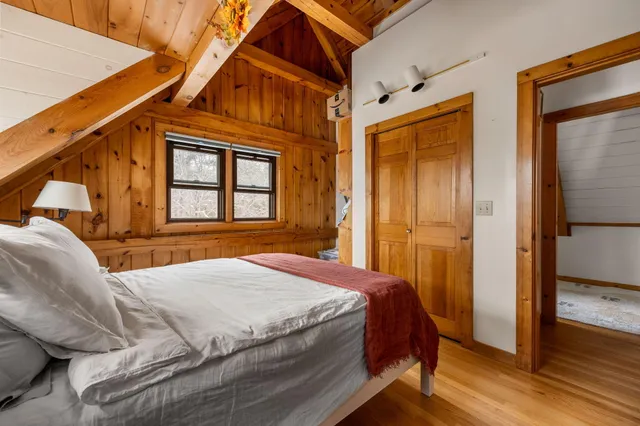 a bedroom with a bed and window