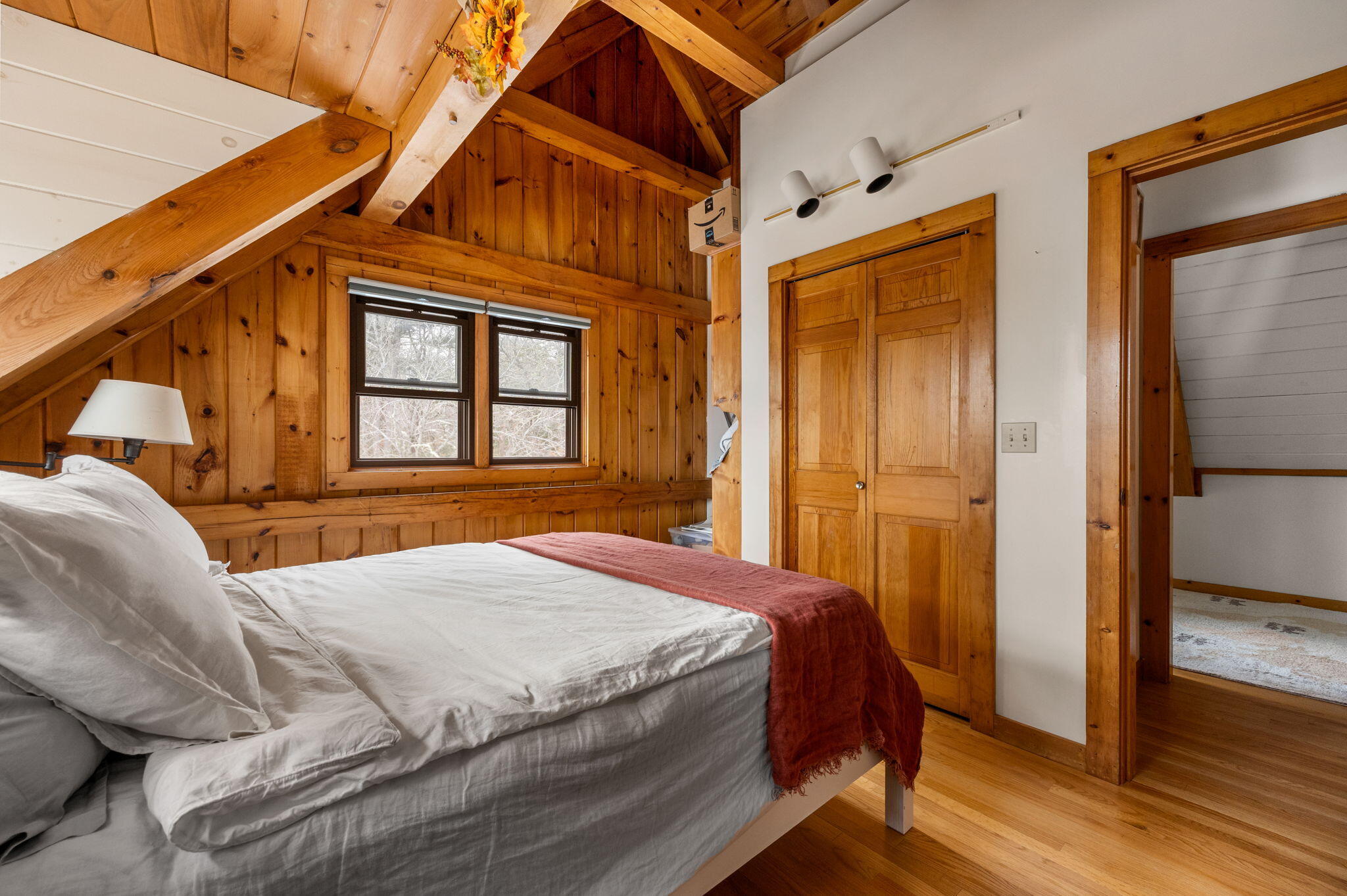 248 Great Neck Road Wareham, MA 02571 - Photo 35 of 54 a bedroom with a bed a mirror and a wooden floor