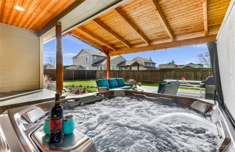 a view of a house with backyard porch and sitting area