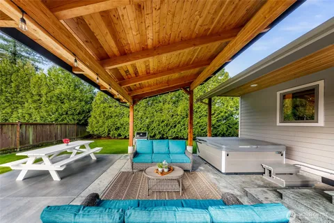 an aerial view of a house with garden space and lake view