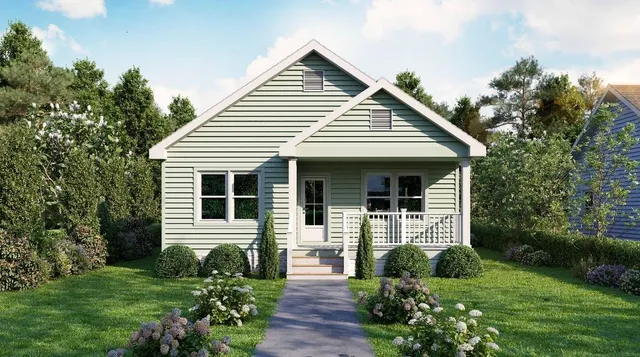 a front view of a house with a yard and outdoor seating