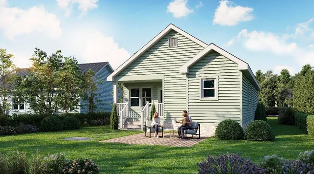 a view of a house with a yard and sitting area