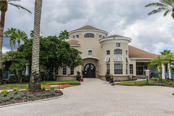 a front view of a house with yard and parking