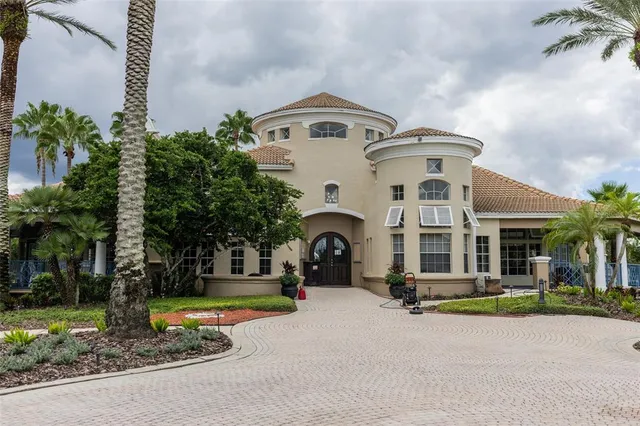 a front view of a house with yard and parking