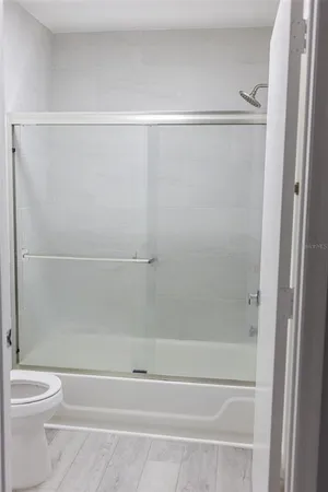 a bathroom with a shower and a toilet