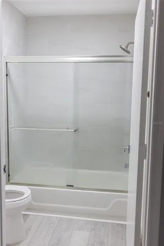 a bathroom with a shower and a toilet