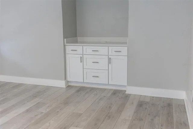 an empty room with wooden floor