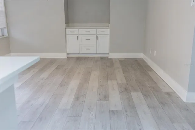 a view of a room with wooden floor