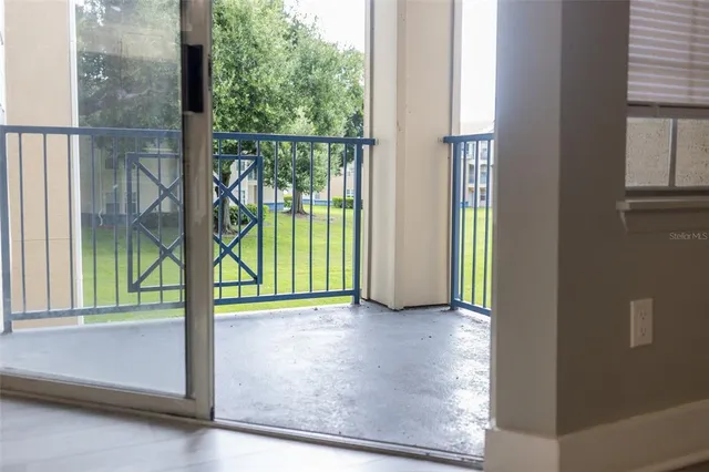 an empty room with floor to ceiling windows and outside view