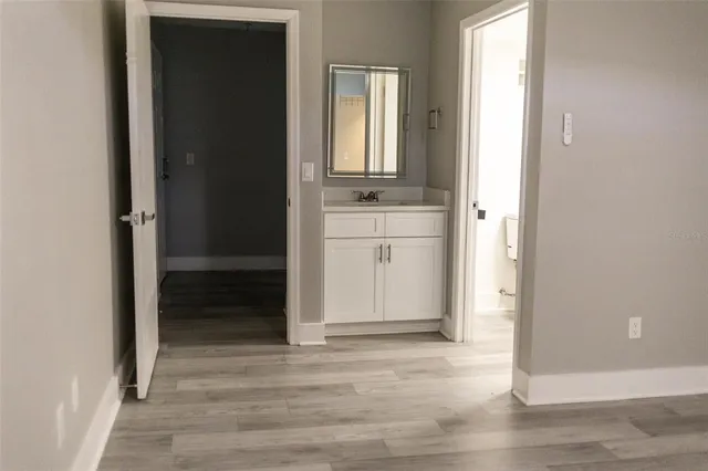 a view of a bathroom with a sink and a mirror