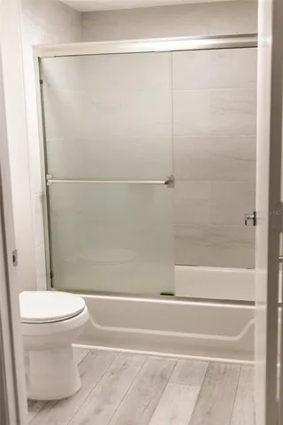a bathroom with a toilet and a shower