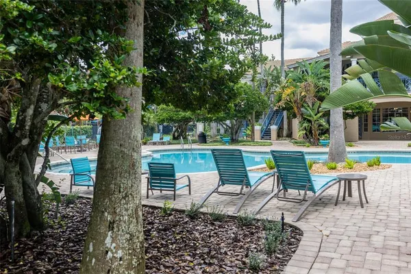 a view of a chairs and table in backyard