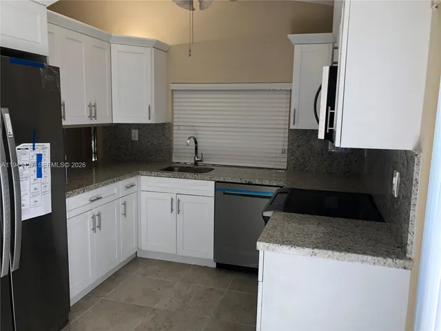 a kitchen with a sink and a refrigerator
